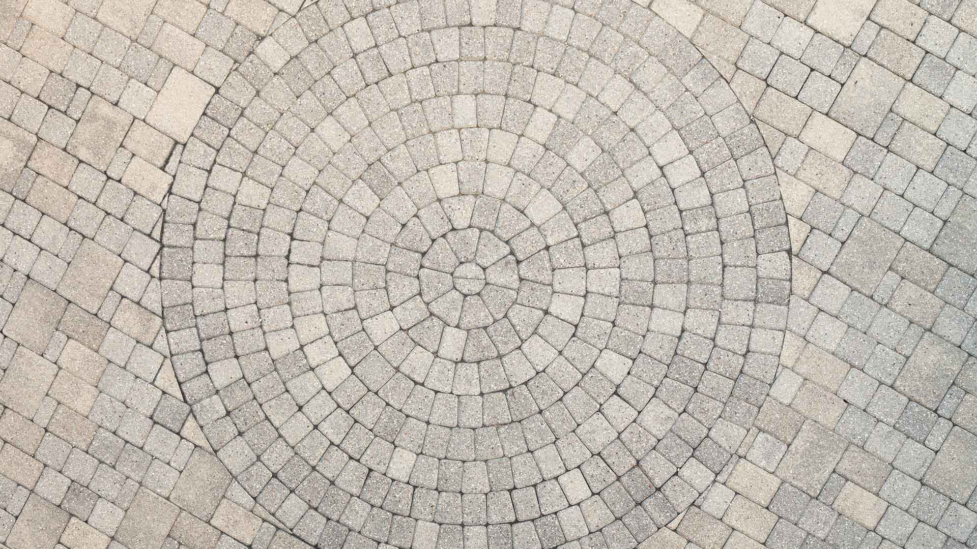 Custom paver patio with circular pattern in Bondurant, IA.